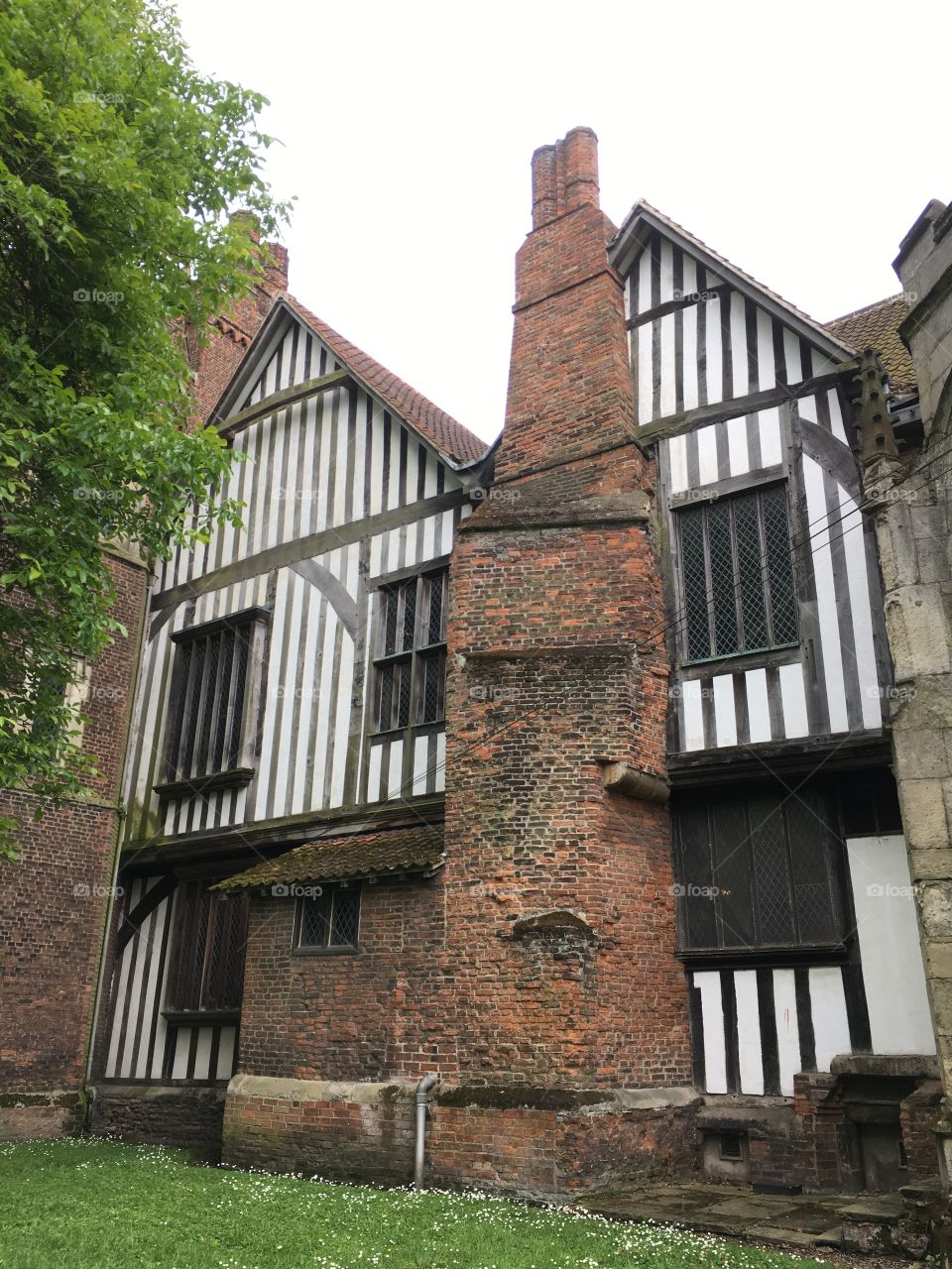 Exterior view of the brickwork and a chimney with timber framing of the medieval Manor House at Gainsborough Old Hall