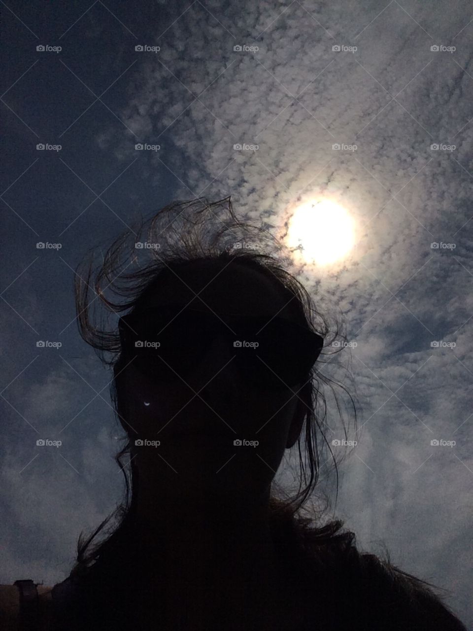 Just a shadow of a human during the solar eclipse in New York City. Look closely and you will see the image of the eclipse on cheek.