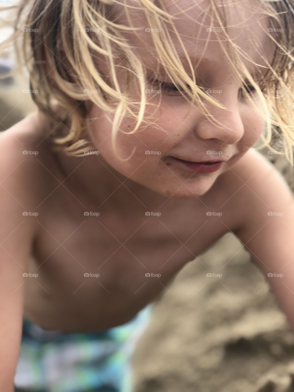 Child Playing at beach closeup profile candid
