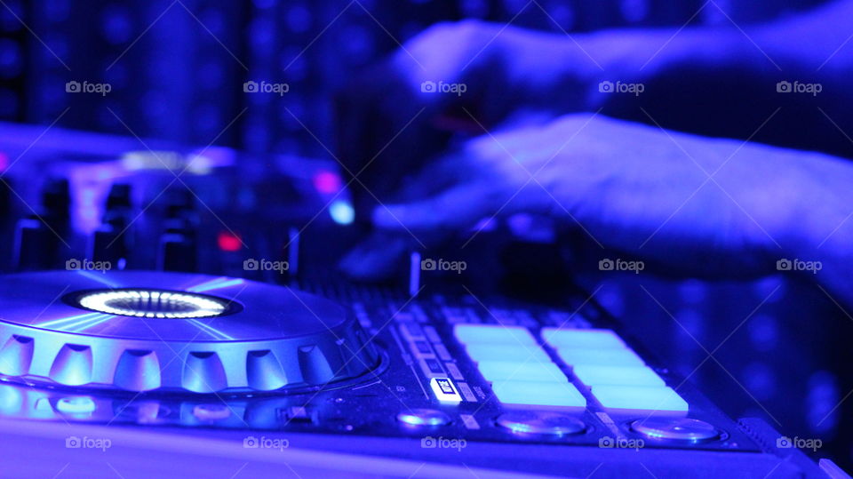 Close up of a DJ's hands on a mixer