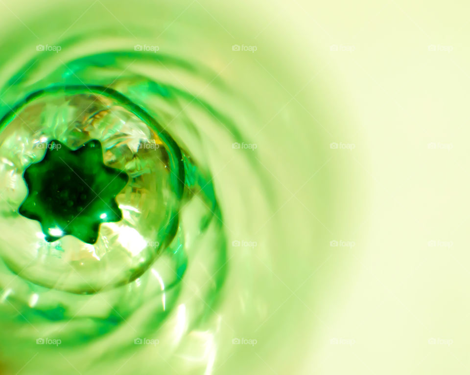 Closeup of green crystal glass selective focus with spiral effect and star shaped center