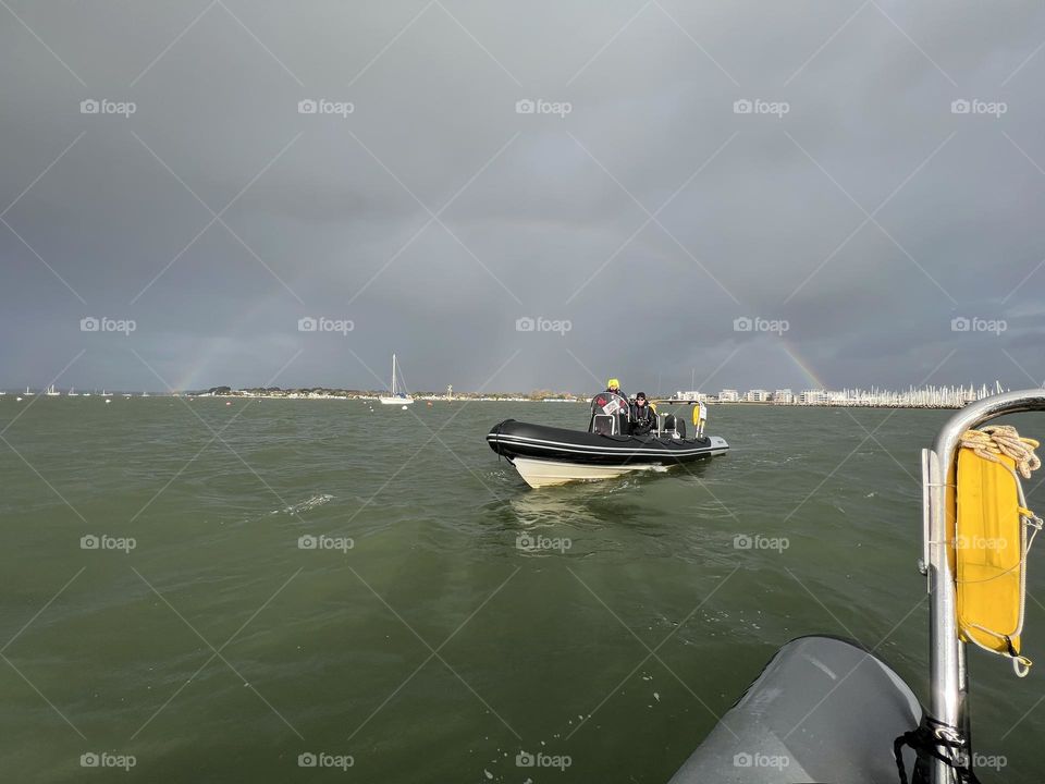 Powerboat under rainbow 