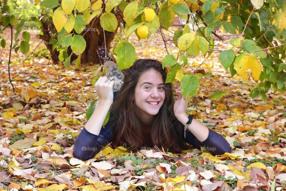 Smiling Young Girl on Autumn Background