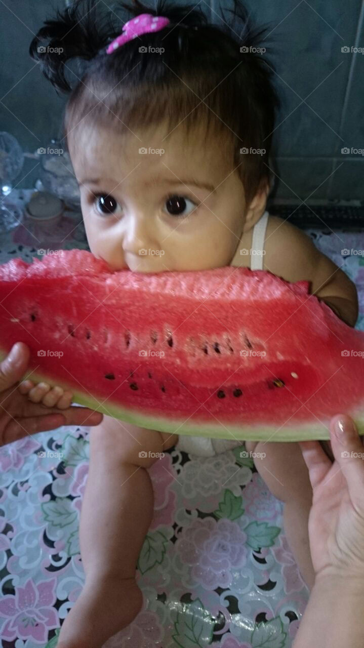 Baby eats a watermelon
