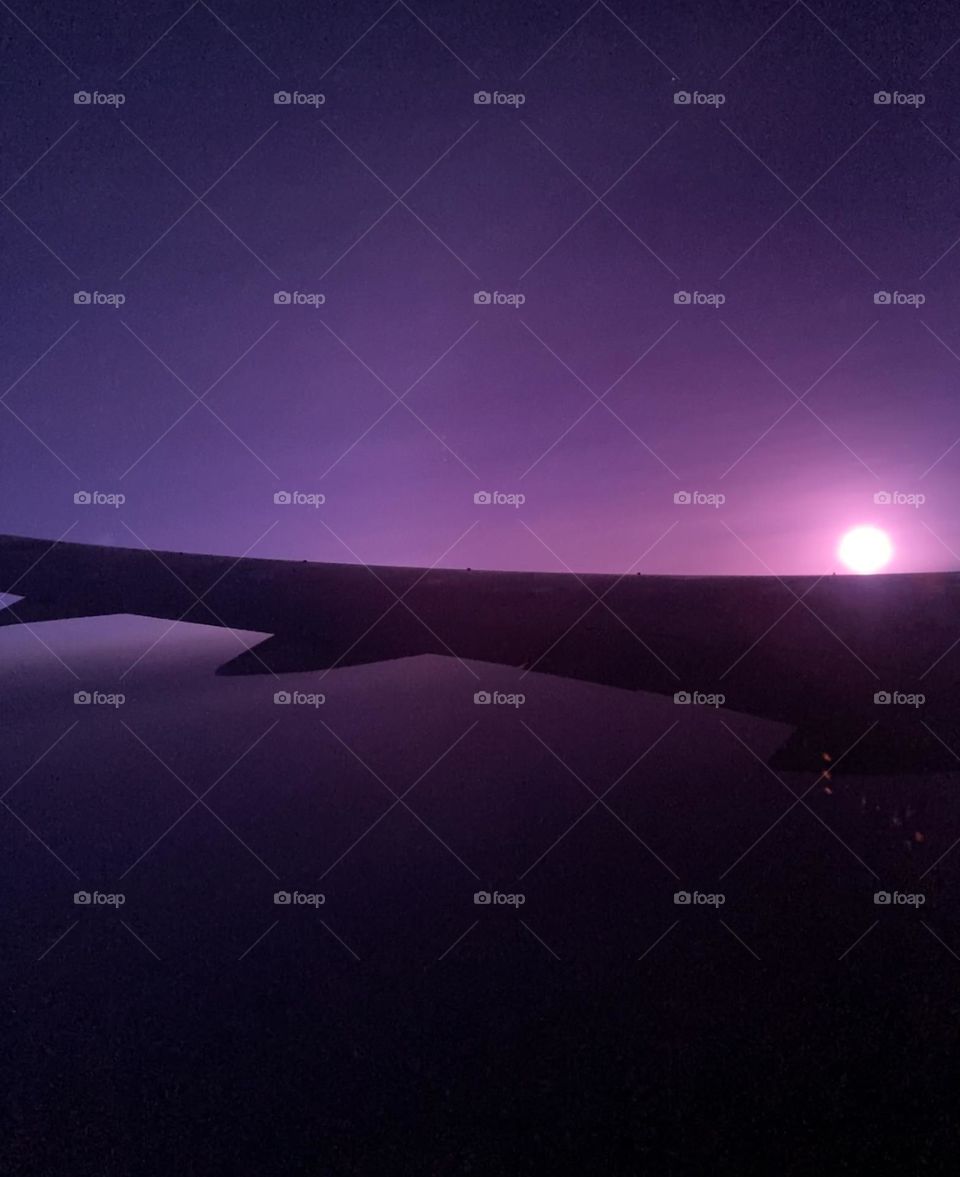 Sundown seen from inside airplane 