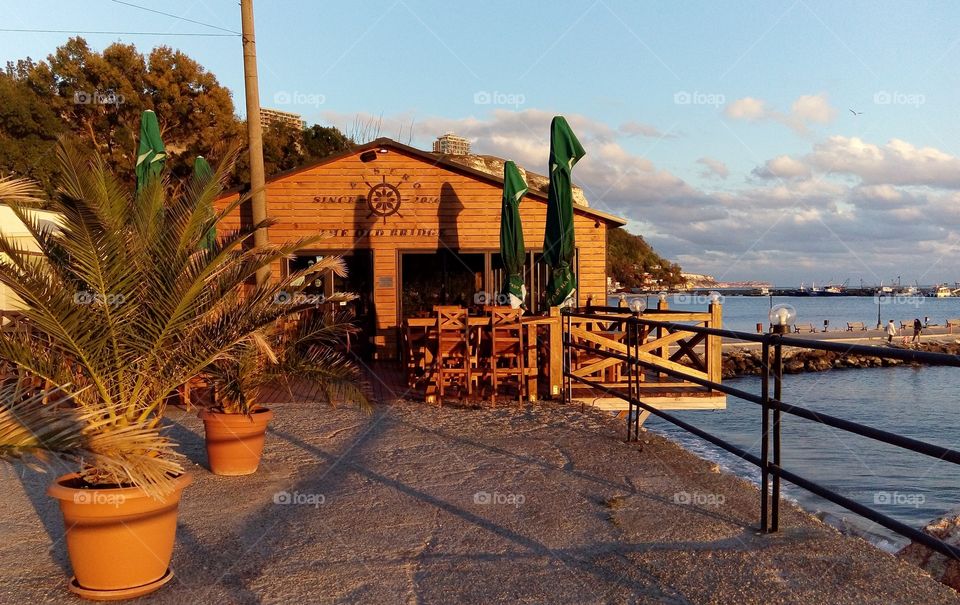 A sunset light over a restaurant on the seashore