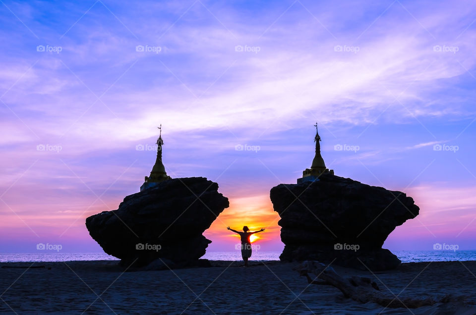 Silhouette of pagodas on rocks on beach at sunset, Myanmar beach