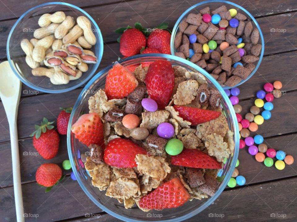 Bowls full of cereals,fruits,candy AND peanuts 