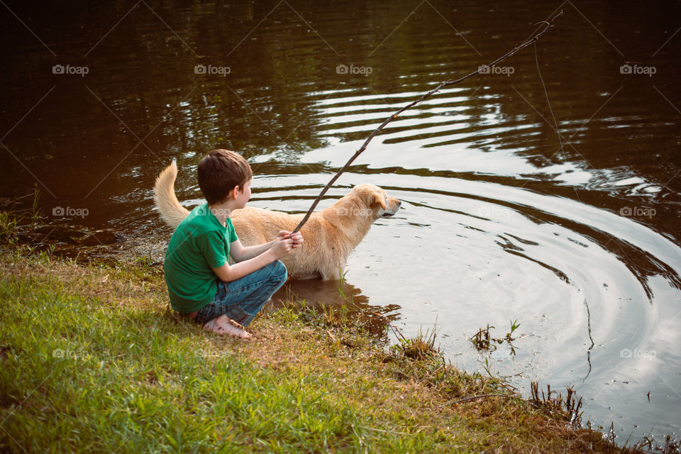 Boy and His Dog Fishing by the Pond