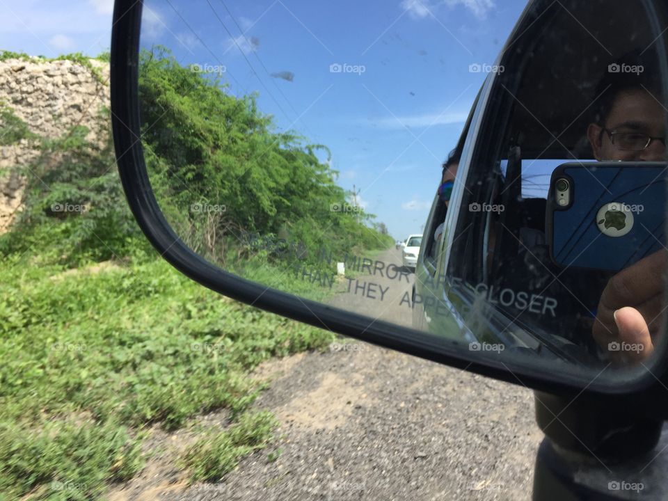 A snap from car side mirror with apple iPhone 