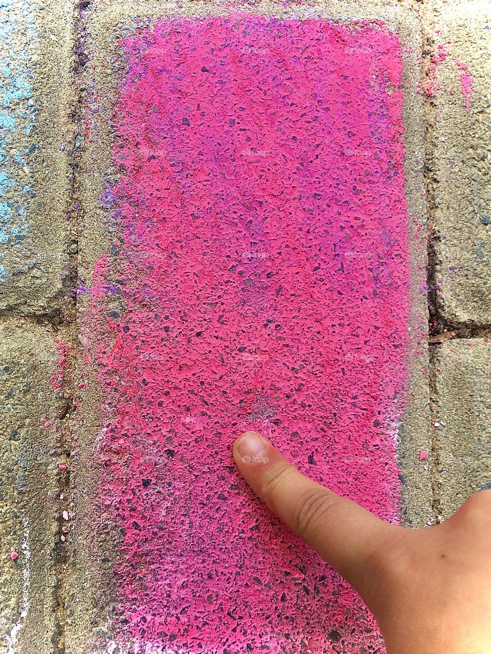 Magenta brick with a kid rubbing the color around