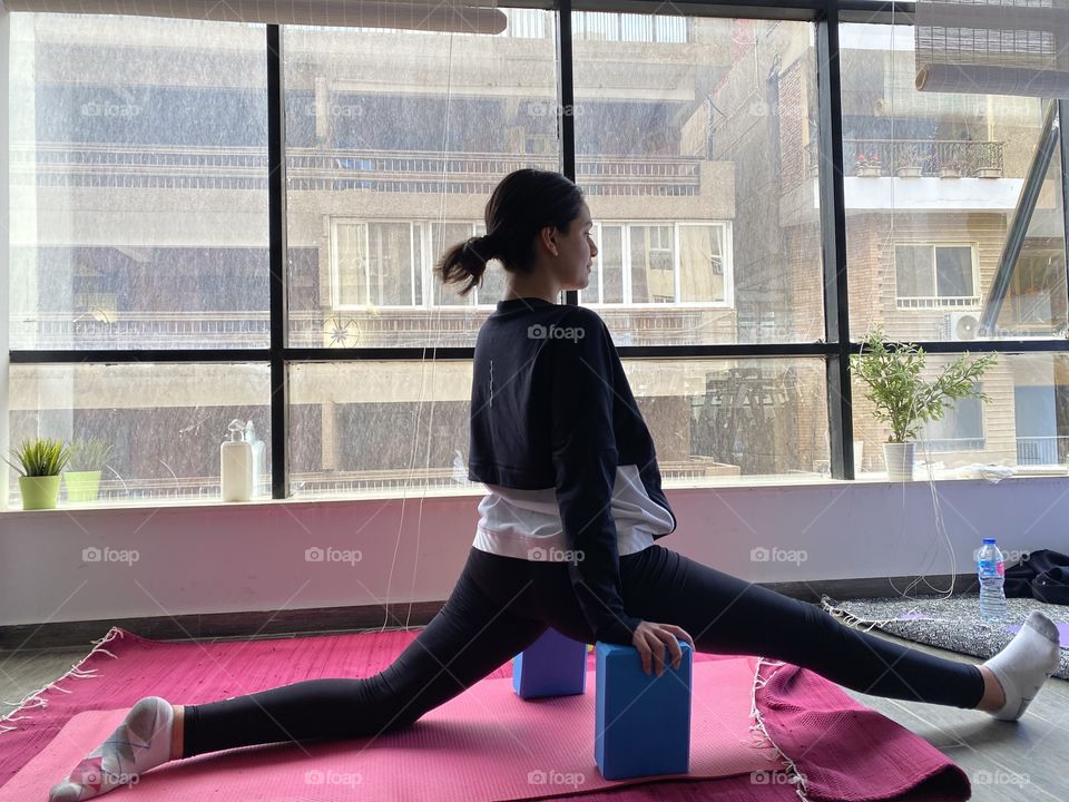 Yoga flexible girl practicing on her splits