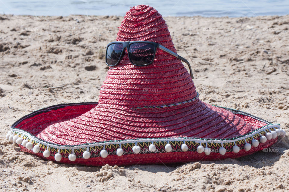 Hat of a sombrero lies on the beach