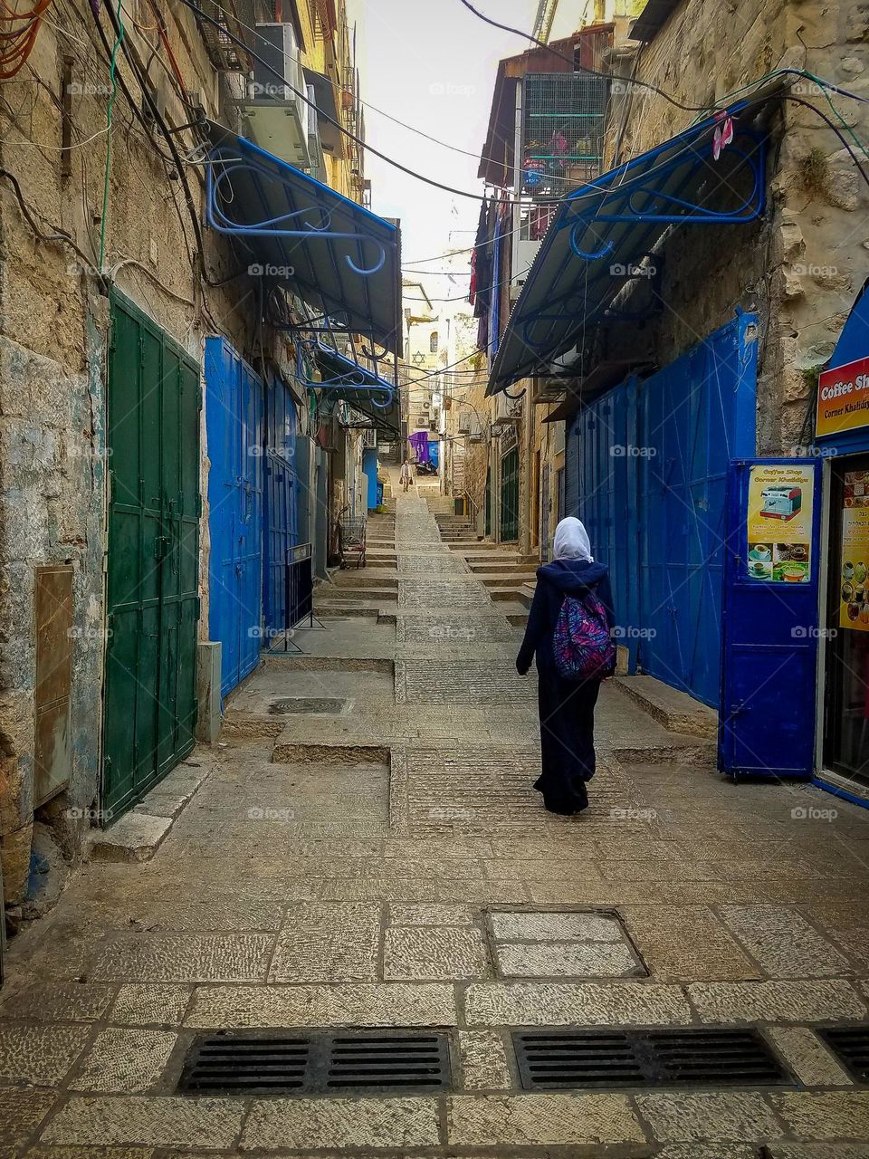 Woman walking down alleyway in the ancient old city Jerusalem