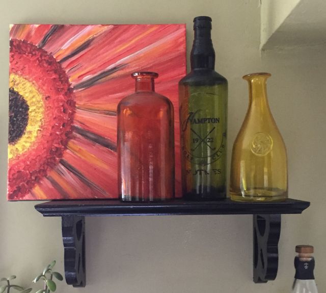 Glass jar and bottle against wall