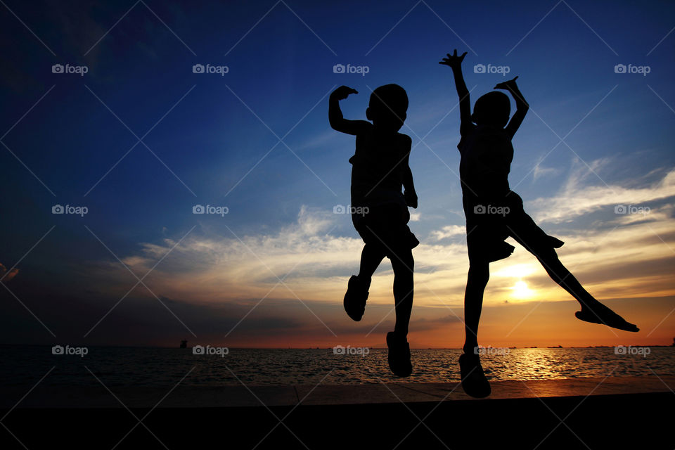 two kids jumping
