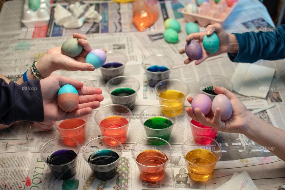 Family Dying Easter Eggs and holding out their favorite ones