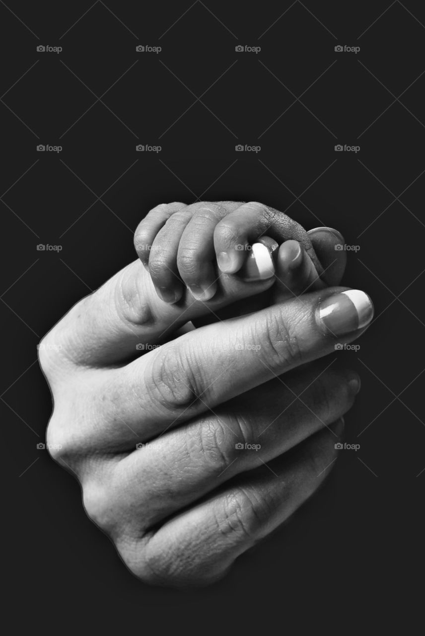 Close-up of mother holding baby hands