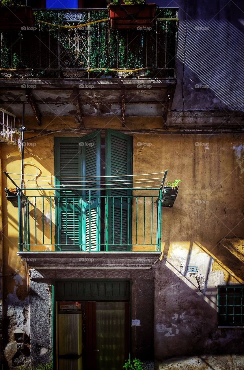 House with a balcony and clothes line, in a town in southern Italy