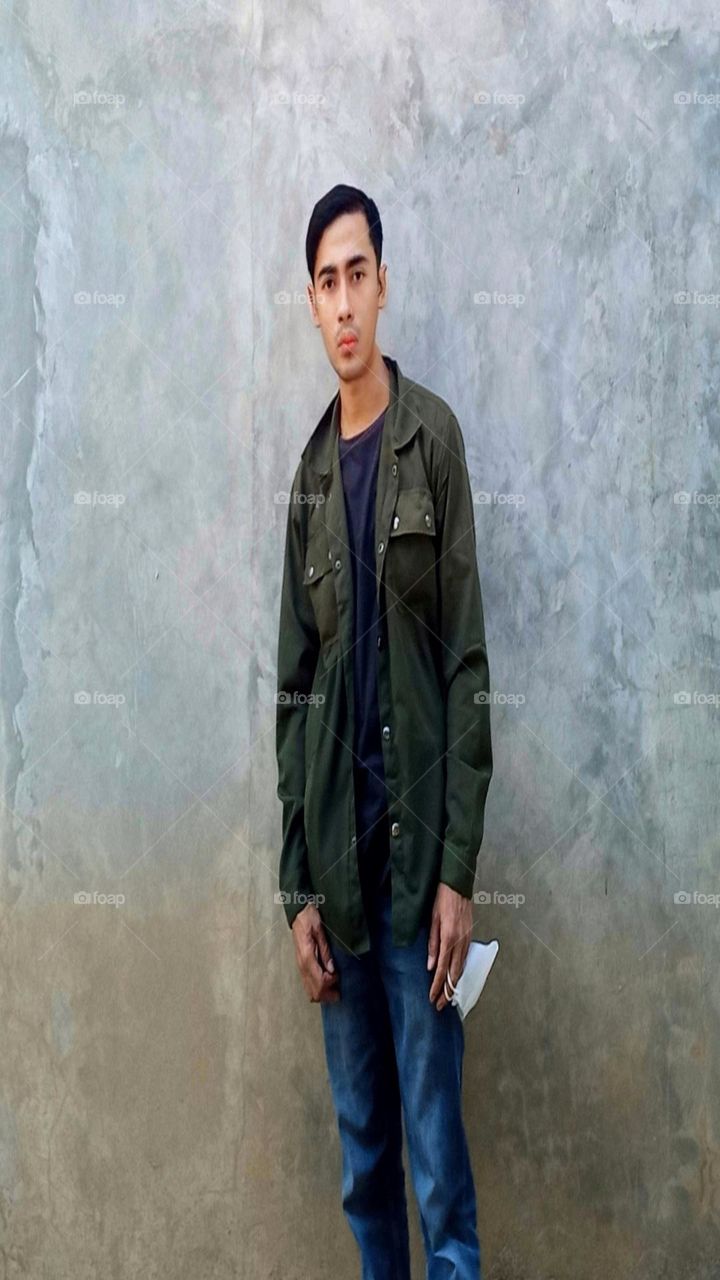 Young man carrying a mask