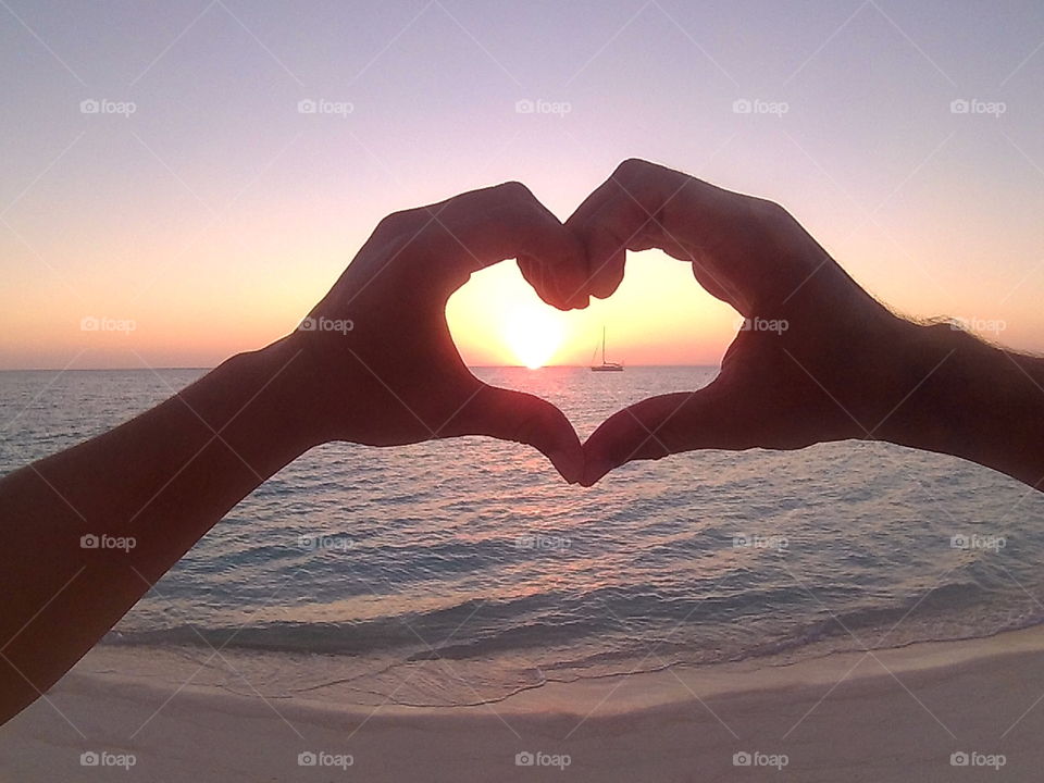 heart shape with sunset and sailboat