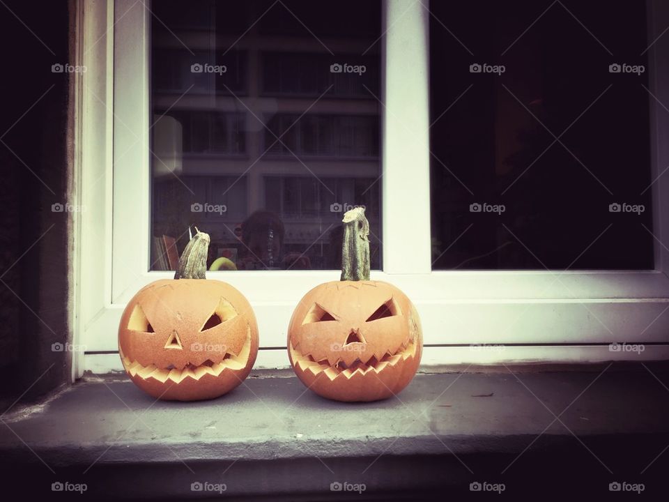 Jack-o-lantern Halloween pumpkins in window