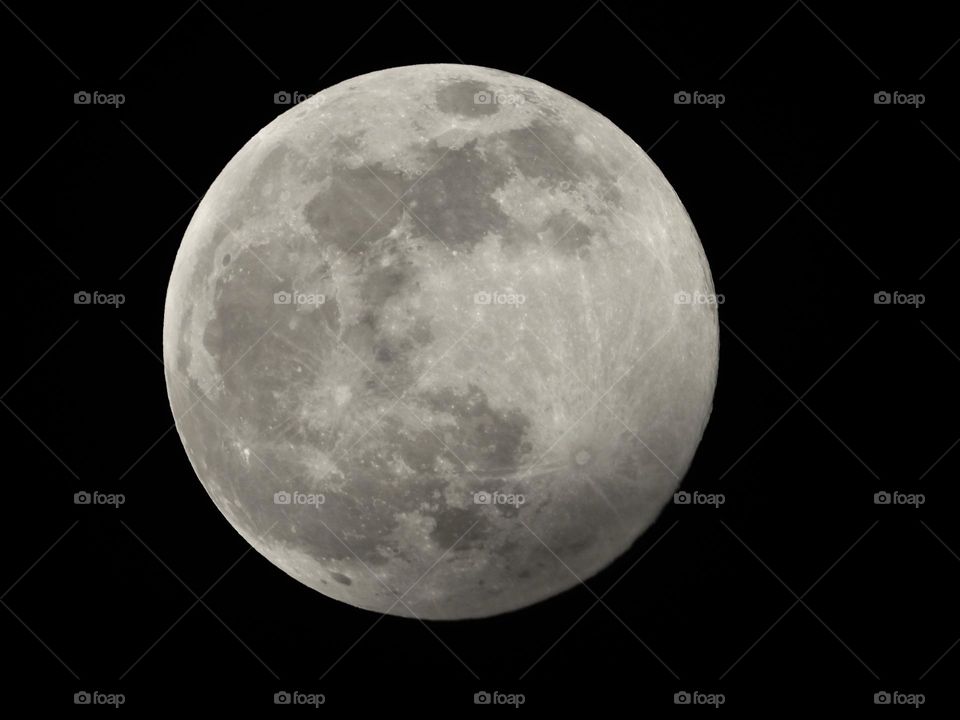 Closeup of majestic Full Moon seas craters visible against blackness of space