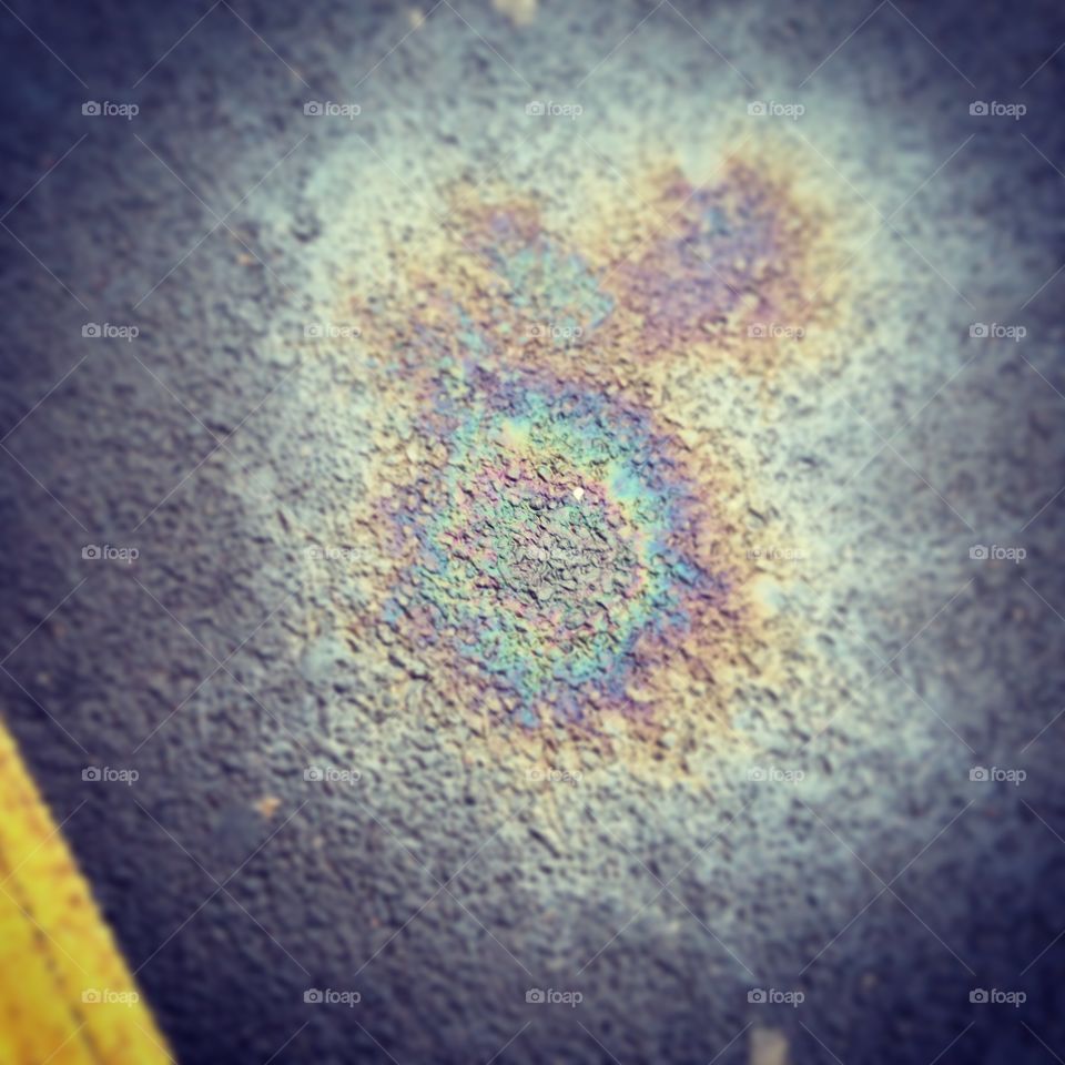 Rainbow in oil spillage on pavement