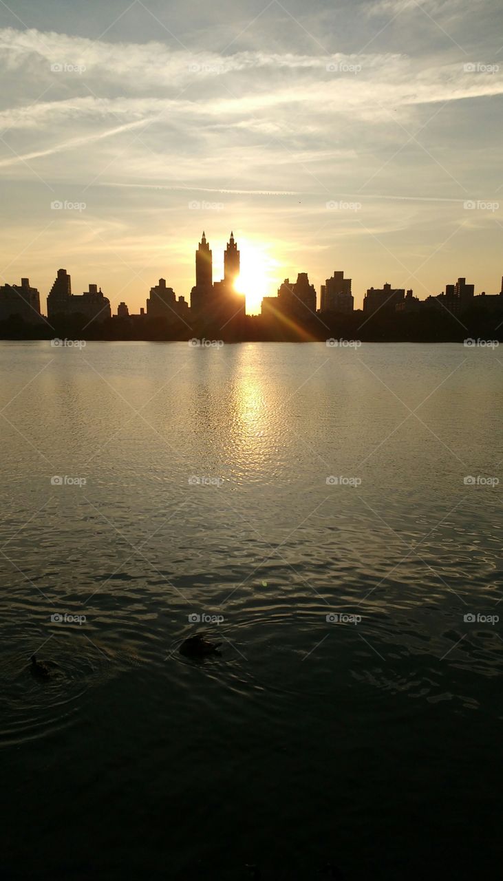 Sunset setting behind buildings