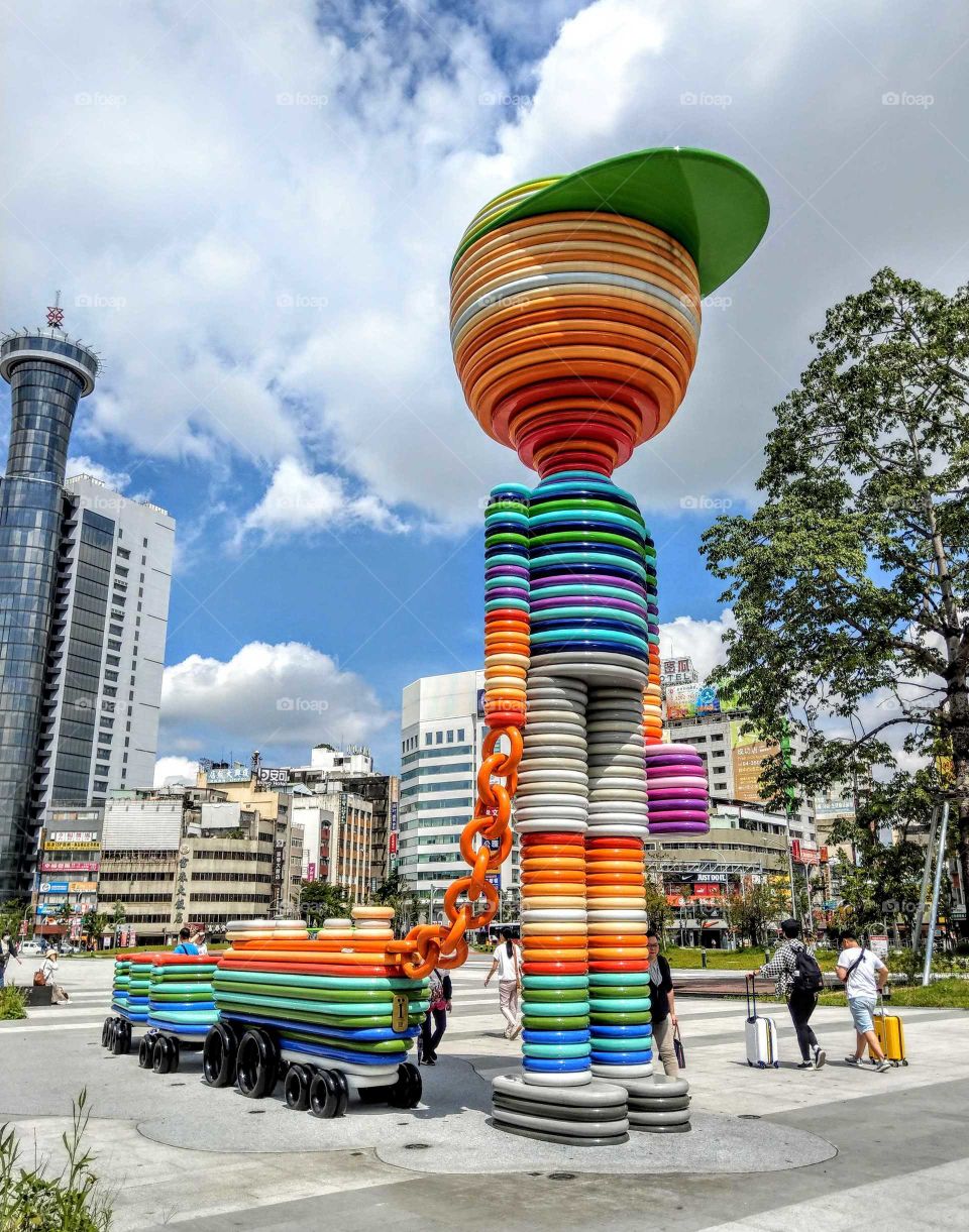 Shapes: Ellipse. a stunning large art works called"Anticipation" or "Travelling kid ". structured colorful stainless steel(circular & ellipse) pipes, build in front of the local train station.