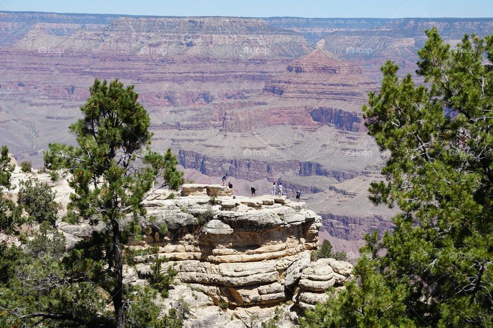 Visitors walk out to a precarious outcrop at Grand Canyon National Park in northwest Arizona
