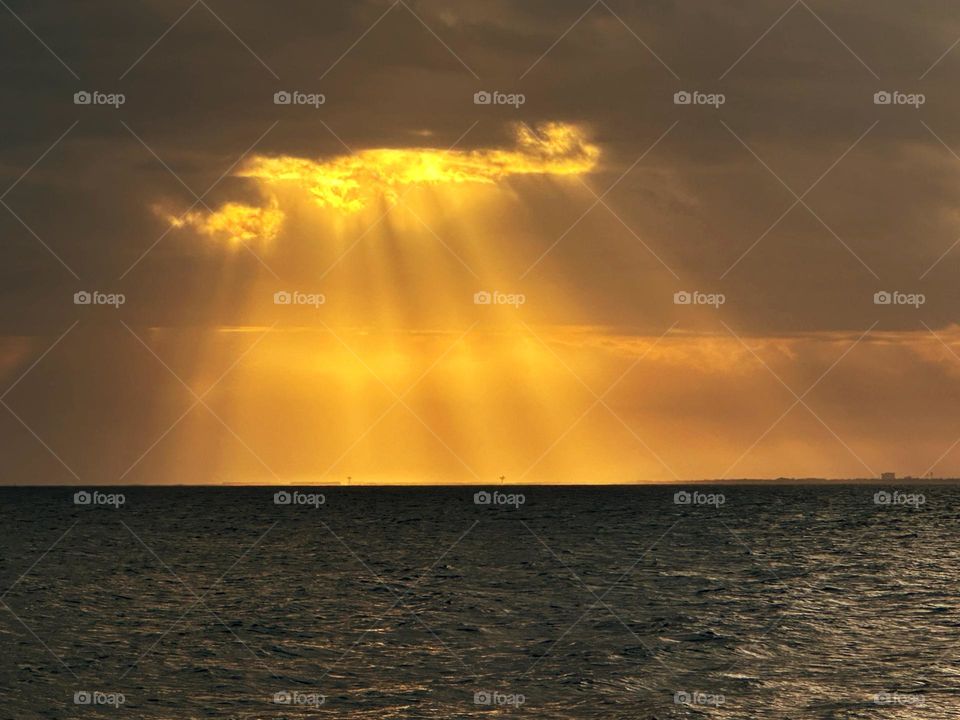 Spectacular Yellow sun rays - Crepuscular rays (also called sun rays and sunbeam) are created when sunlight shines through gaps in clouds and continues through an atmosphere that contains dust or haze