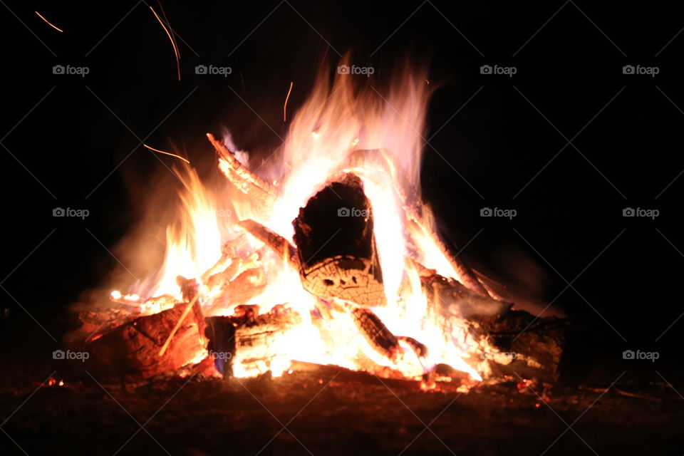 A roaring fire after dark has set in.