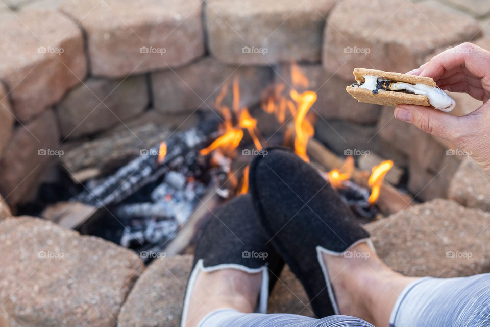 Eating S'mores and relaxing by the fire