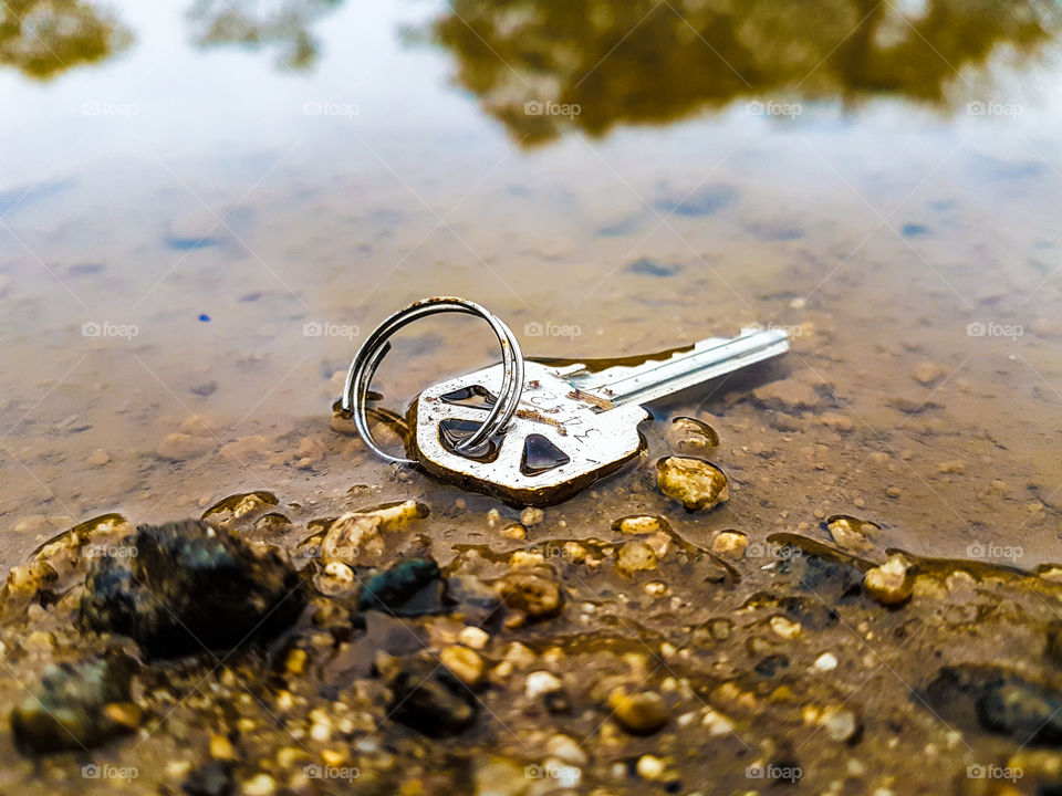 a Lost key in a puddle of water
