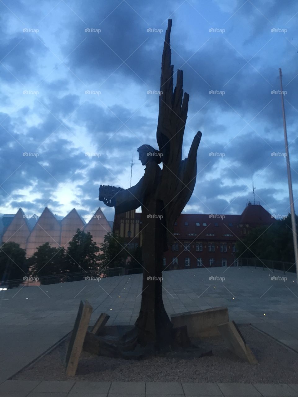 A statue of an angel in the square in front of Philharmonic hall in Szczecin in the twilight 