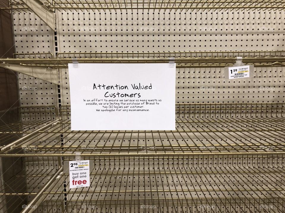 Empty store bread shelves with notice