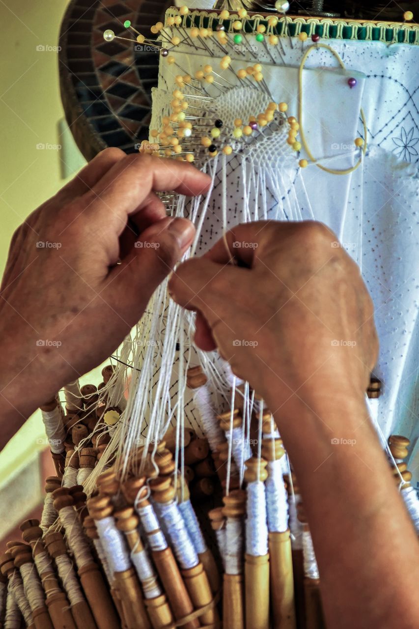 Crafting a beautiful table cloth with bobbin lace.