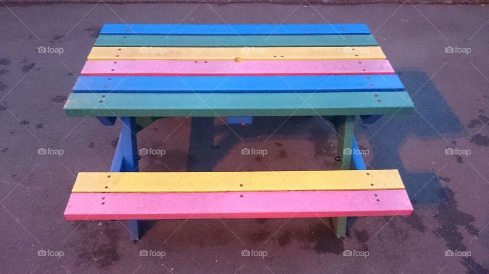 Wooden multicoloured picnic bench at Cadbury World, Bournville, Birmingham. After a Summer visit to the famous chocolate factory.