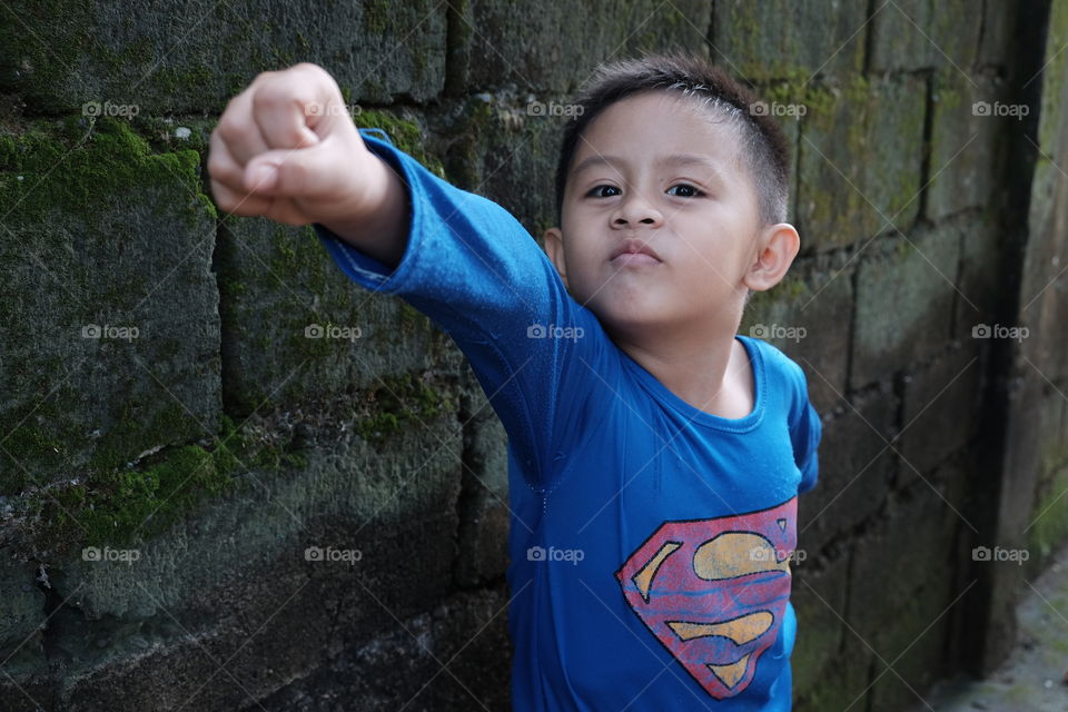 Playful portrait that shows more fun to come. This photo shows a boundless imagination of a child. 