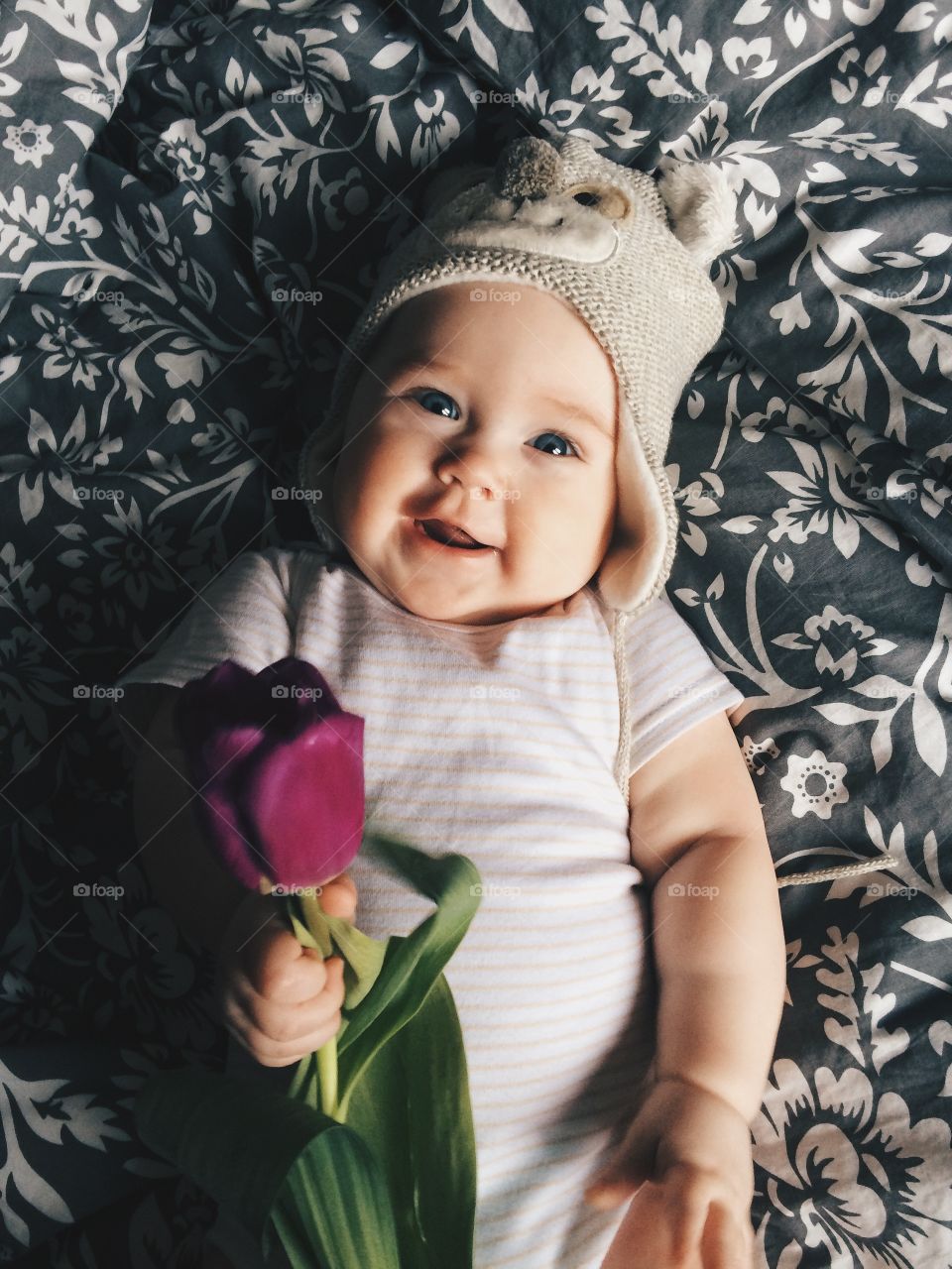 Cute smiling baby-girl with a flower
