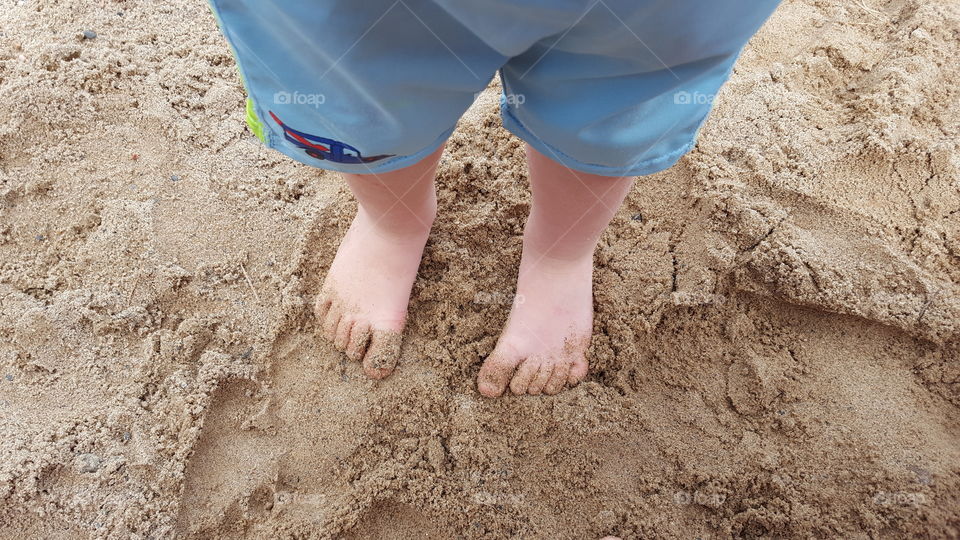 toddler toes on a sandy beach