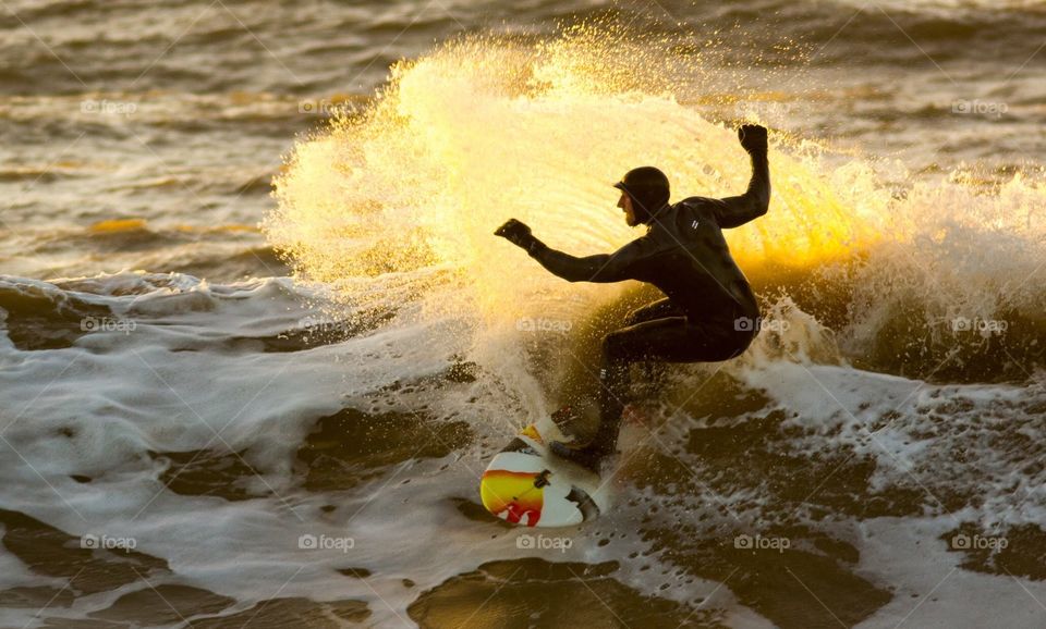 Winter surfing at sunset