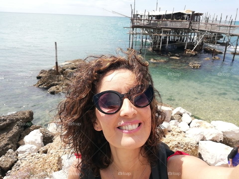 portrait of a woman by the sea on the "trabocchi coast" in Abruzzo (Italy)