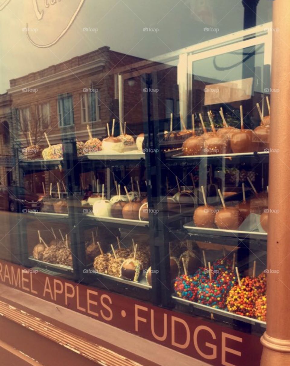 Window shopping. Carmel apples in window of local business