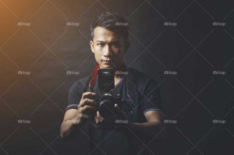 Portrait of a photographer with camera