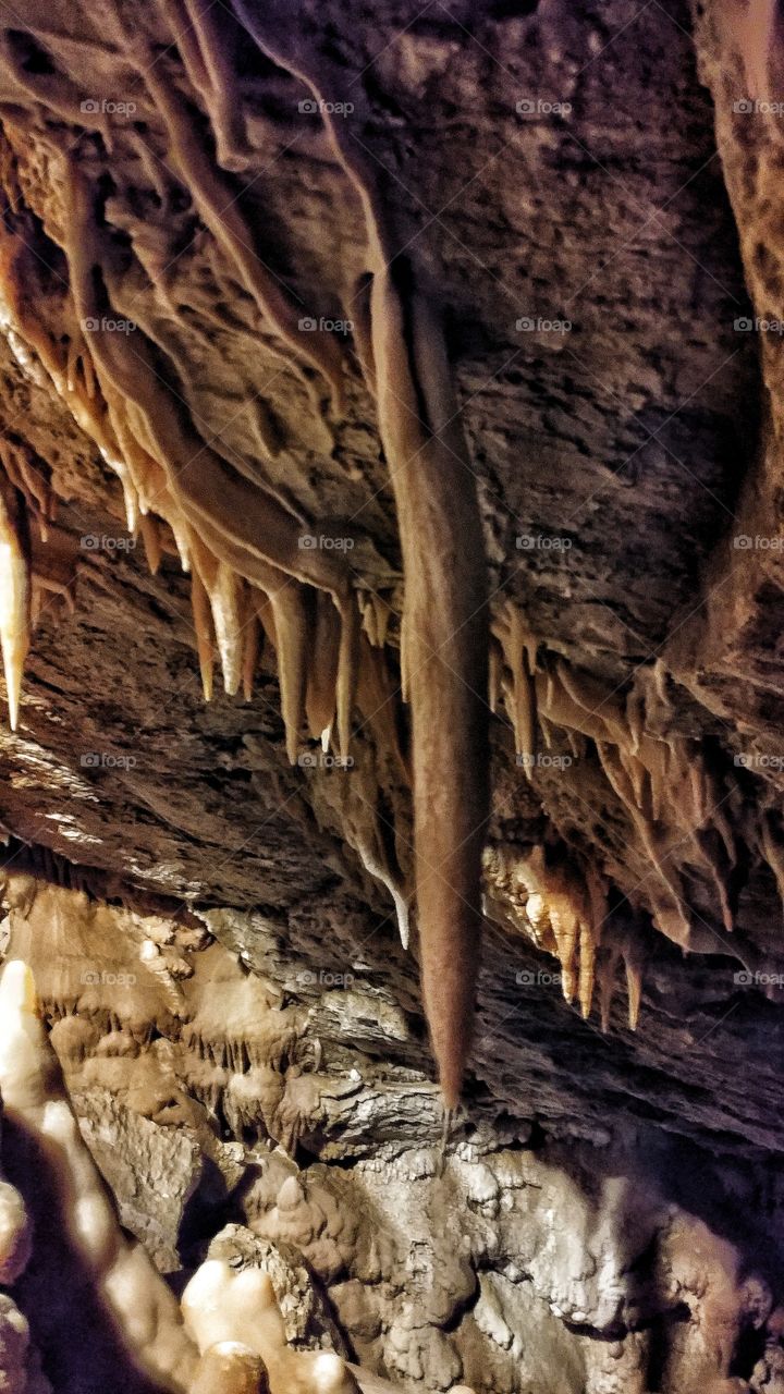 Ribbons of minerals flow beautifully down the cave walls of this magnificent ancient cave.