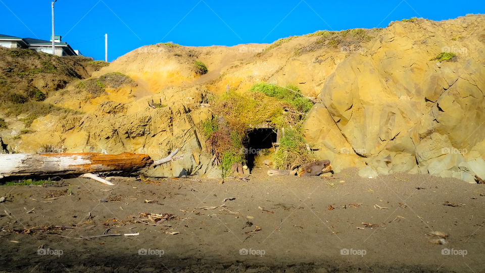 Man made cave out of Driftwood, grass and seaweed