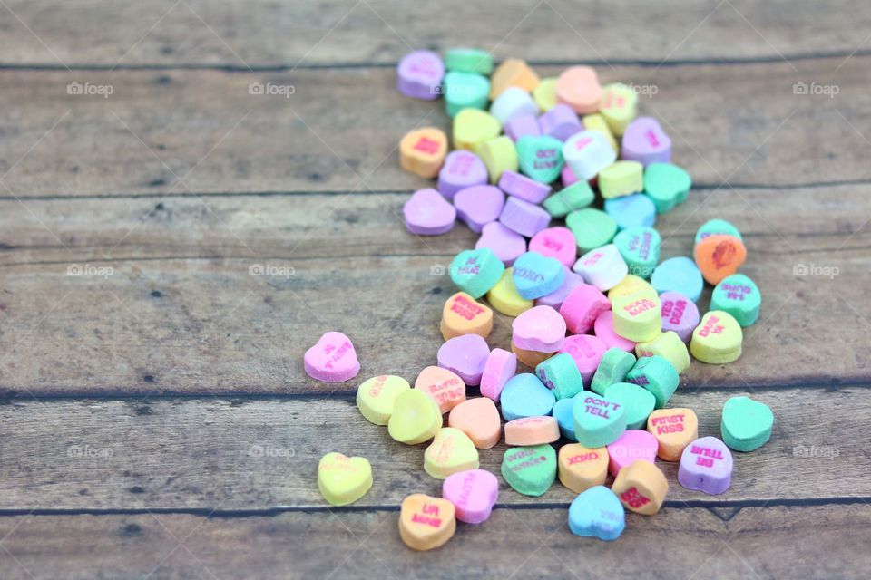 Candy Hearts on wooden table top