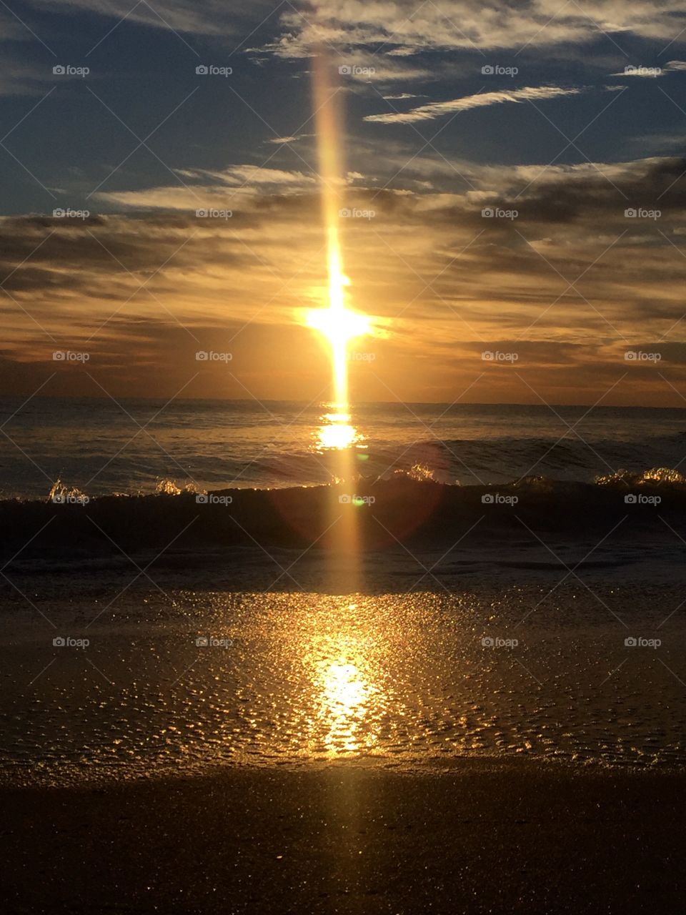 This was taken at Oceanridge FL, as the sun rose, creating a cross by the reflecting rays, that is what I call Devine 